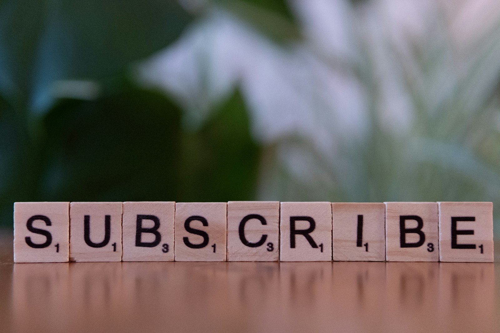 Don’t Miss a Beat (Or an Outfit)! 1 A wooden block spelling subscribe on a table
