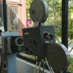Vintage film projector and camera on display, Stories