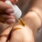 person holding dropper, beauty, makeup, perfume, collection, skin care