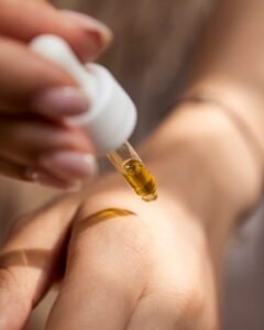 person holding dropper, beauty, makeup, perfume, collection, skin care