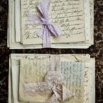 Stacked vintage handwritten letters tied with lace on a textured surface.