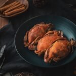 a plate of cooked crabs on a table, shellfish, seafood