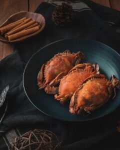 a plate of cooked crabs on a table, shellfish, seafood