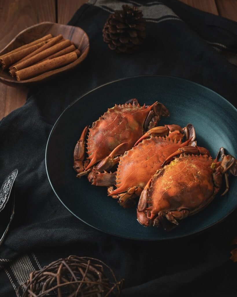 a plate of cooked crabs on a table, shellfish, seafood