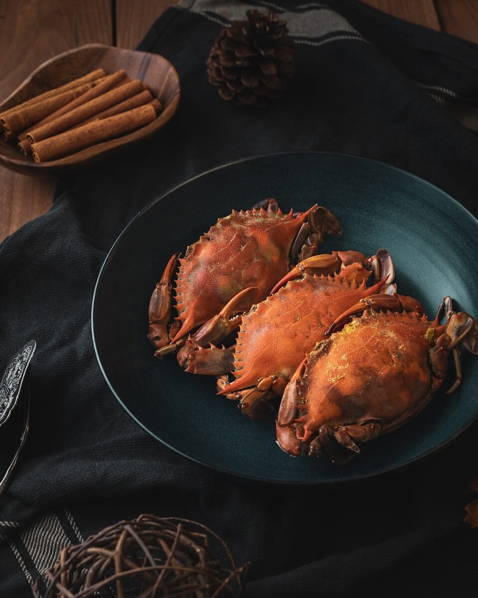 a plate of cooked crabs on a table, shellfish, seafood