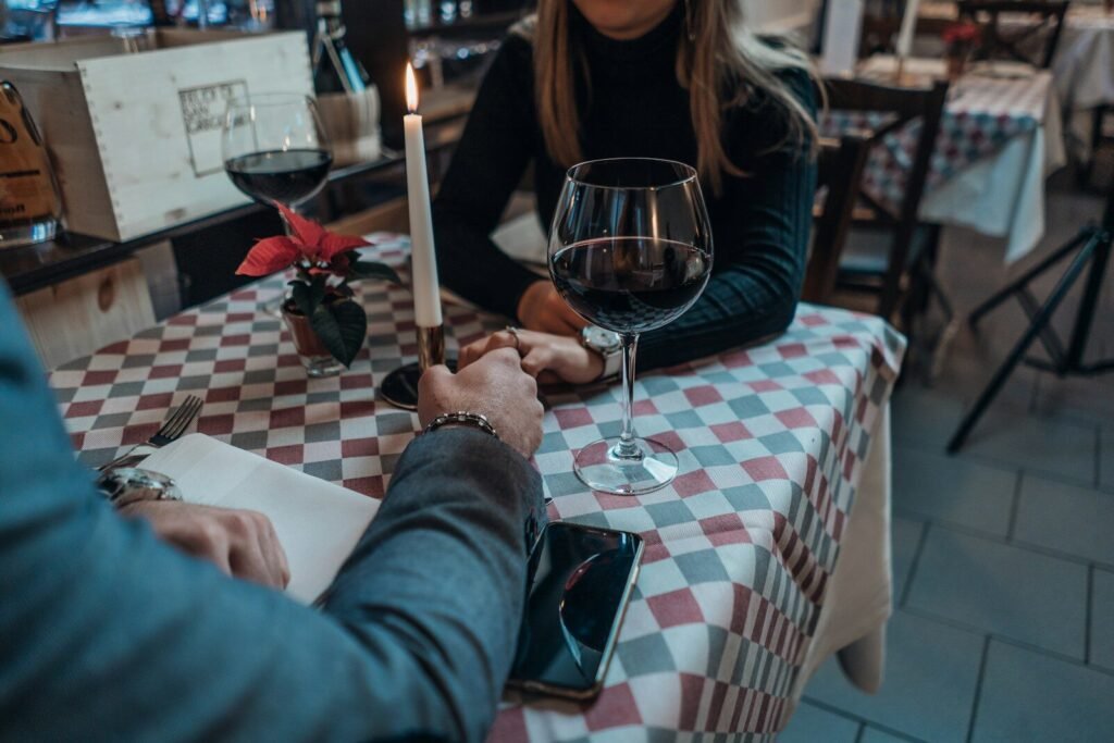 woman wearing black sweater holding hand with man wearing gray suit jacket, speed dating