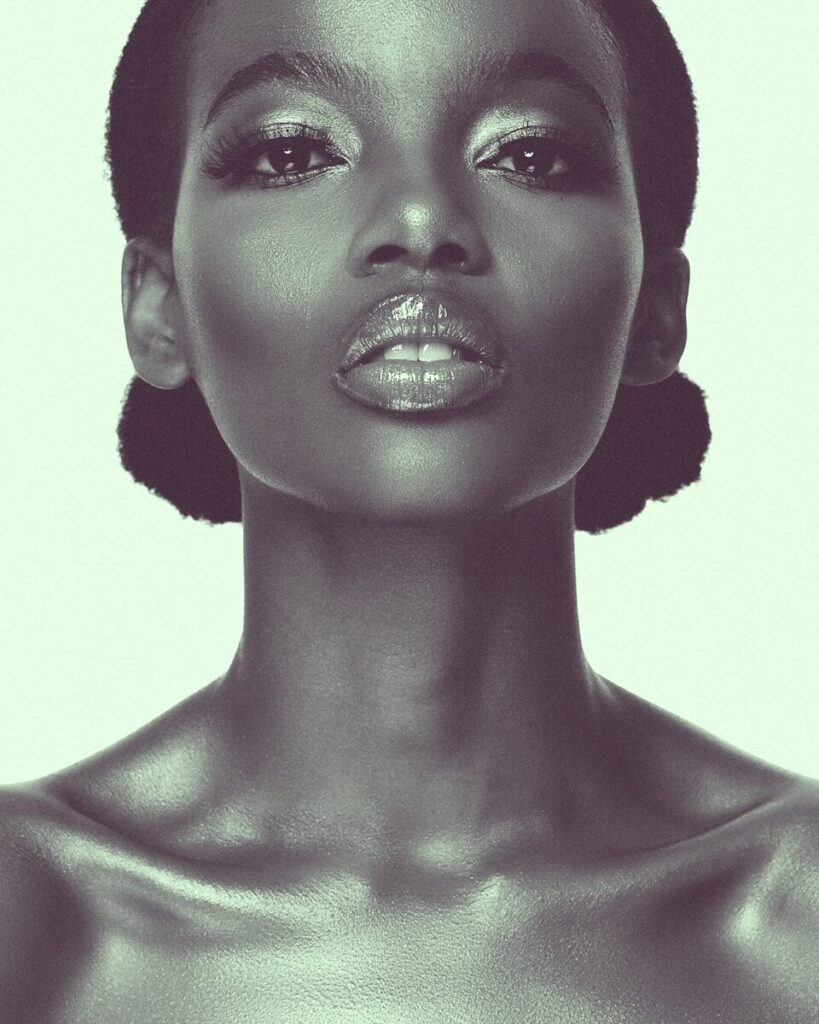 a woman with black hair and a silver make - up, beauty